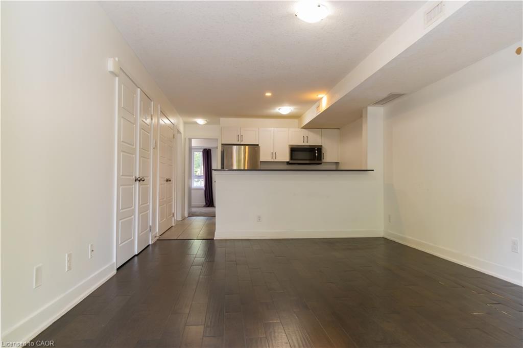 Open-concept living area with dark wood-finish flooring