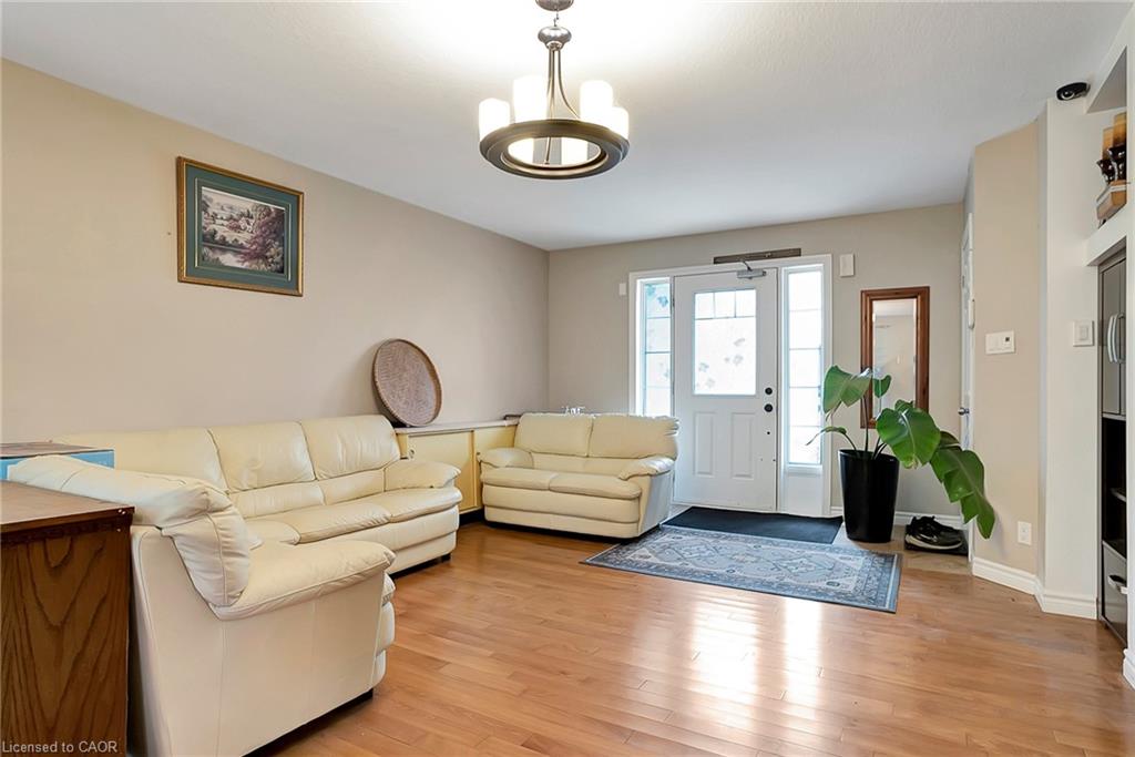 Living area with a chandelier and light wood-type flooring