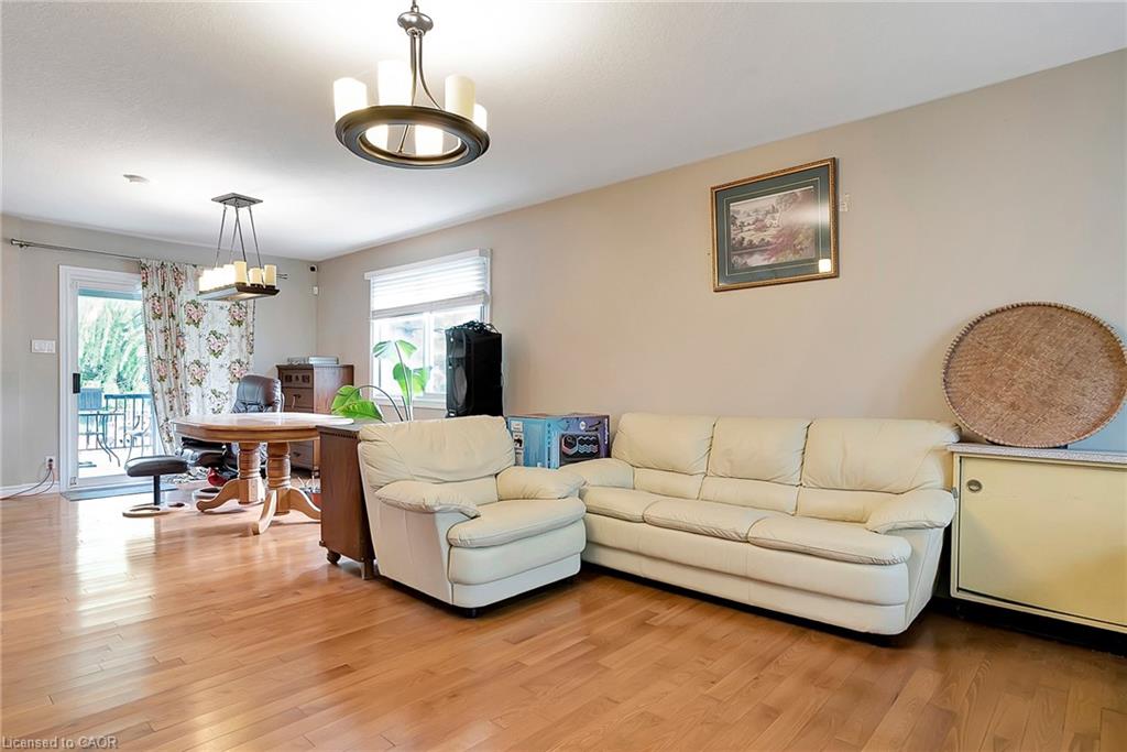 Living area with light wood-style flooring and a chandelier