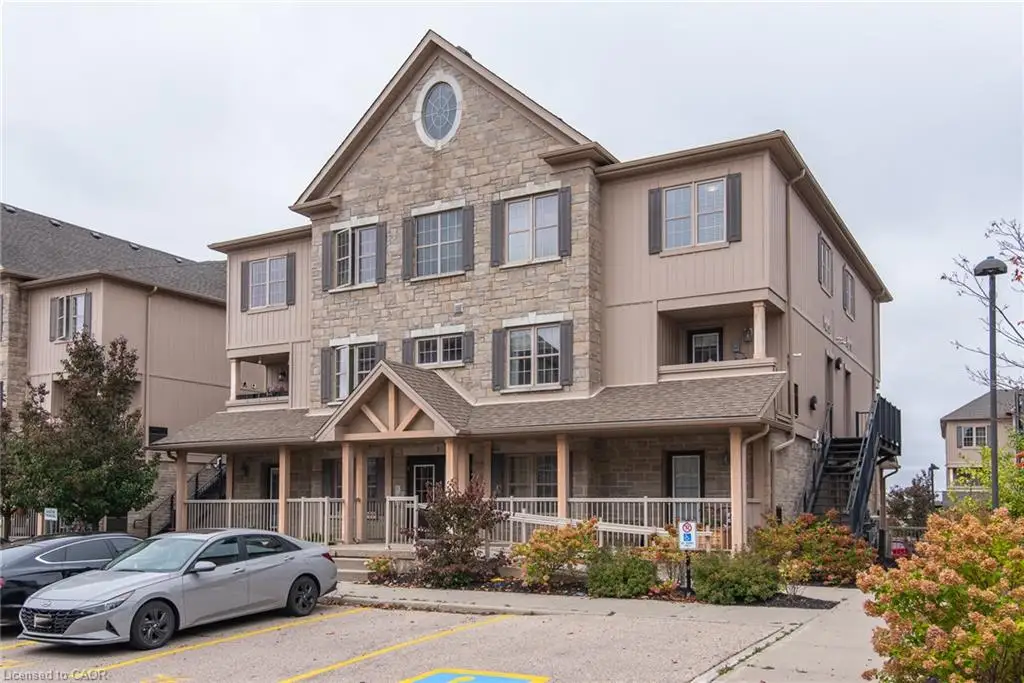 Multi-story exterior featuring stone veneer facade, gabled roofline, oval accent window, and covered ground-level porch with wood-finished support columns