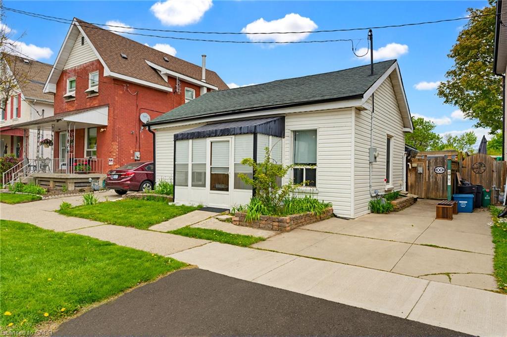 White vinyl siding exterior with an asphalt shingle roof