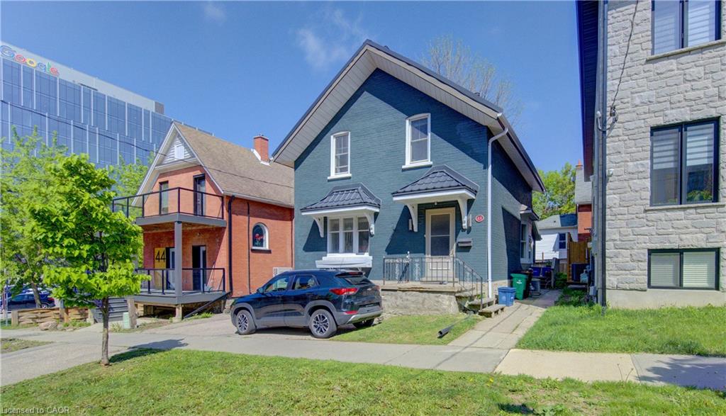 Two-story residence with steel roof, white trim windows, and a covered entry