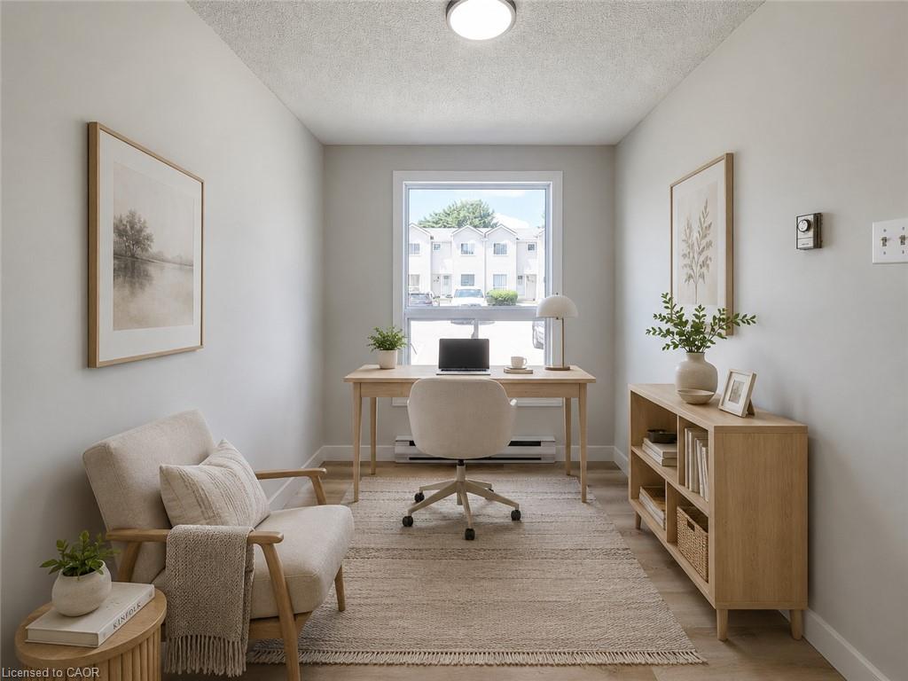 Light-filled room featuring a single window, light wood-finish flooring, and neutral wall paint