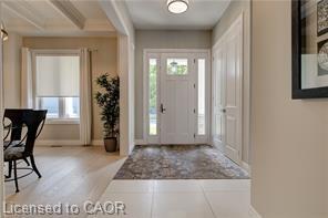 Entryway featuring a white paneled door with glass inserts, recessed lighting, and tile flooring