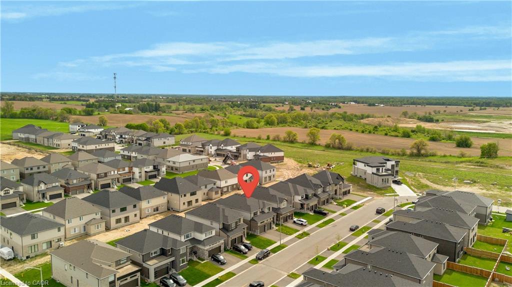 Aerial perspective of a developed residential area bordered by open fields