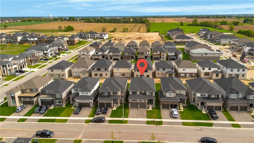 Residential neighborhood featuring a grid-pattern street layout, uniformly landscaped front yards, and paved driveways