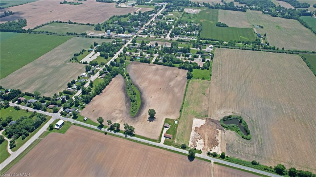 Aerial view of property and surrounding area with rural landscape and rows of crops