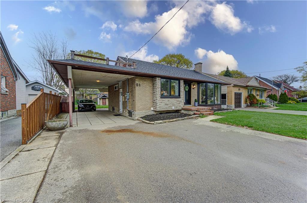 Brick and stone-clad exterior with an attached carport