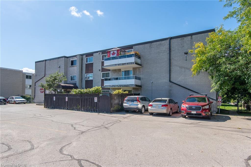 Brick exterior with multiple balconies and a dedicated parking area