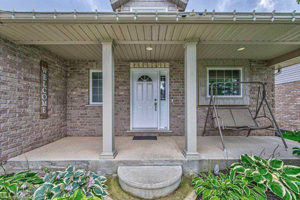 Brick facade with a covered porch featuring white columns