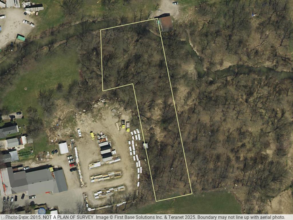 Aerial Photograph. Displaying the property boundary overlaid on an aerial image and noting its non-survey status