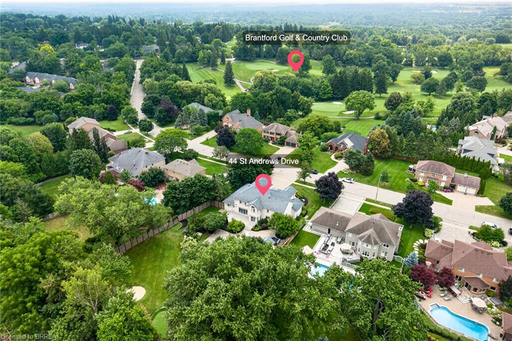 Aerial perspective showcasing a residential neighborhood with ample tree coverage