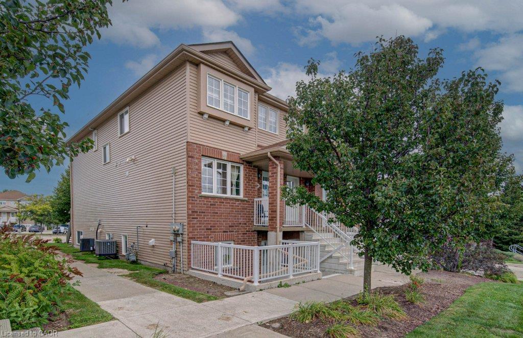 Multi-story exterior with horizontal siding and brick accents