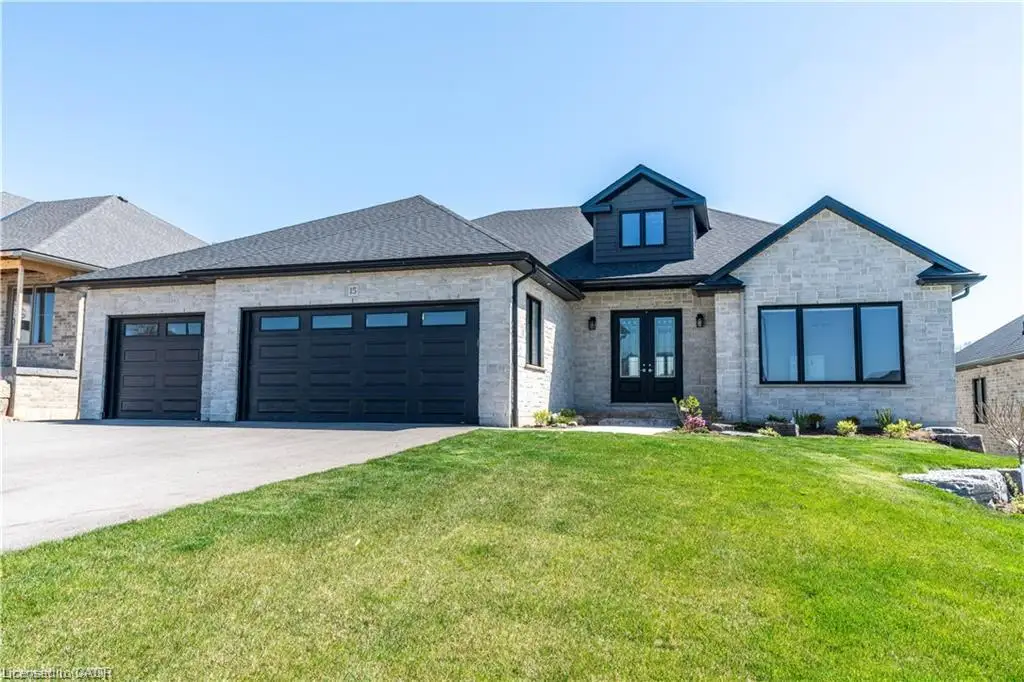 Stone veneer exterior featuring a prominent gabled dormer and a covered entry with double doors