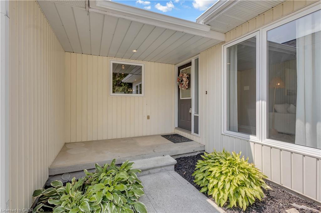Covered front entry with concrete steps and landing