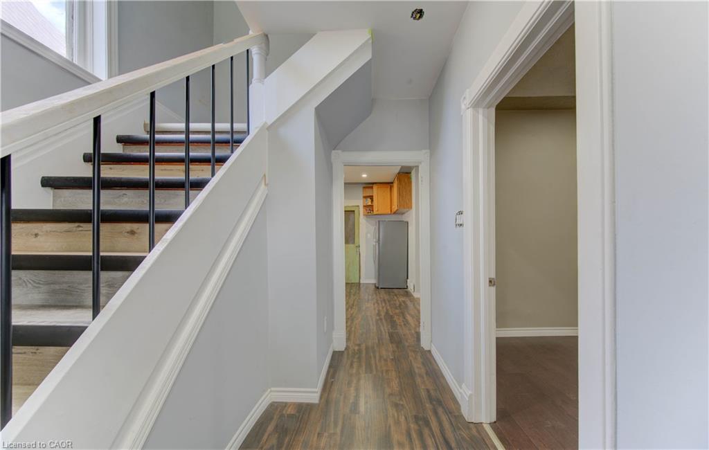 Staircase with wood finished floors and baseboards