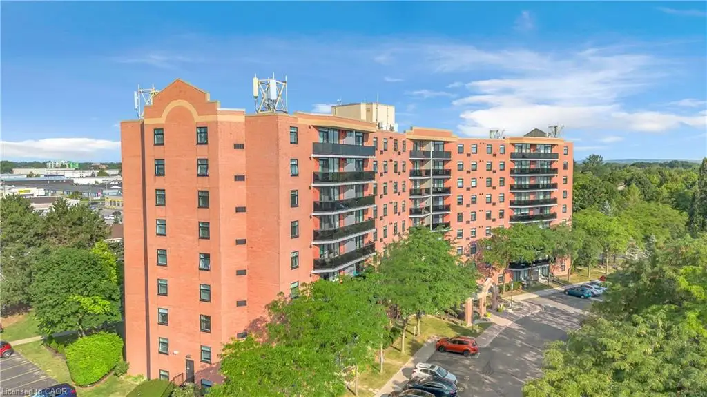 Brick exterior multi-story building featuring multiple private balconies with black railings