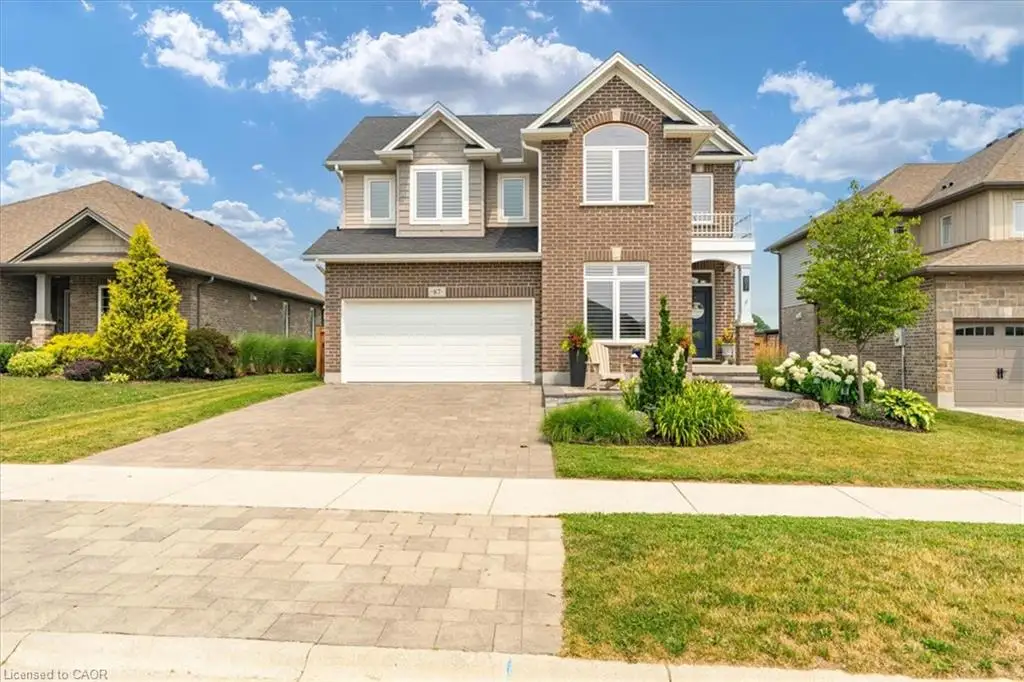 Two-story brick and siding residence with a paver driveway
