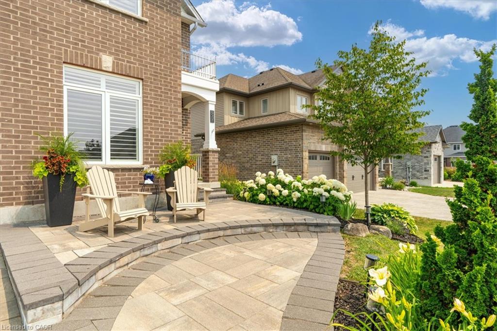 Brick facade featuring white trim windows with louvered shutters