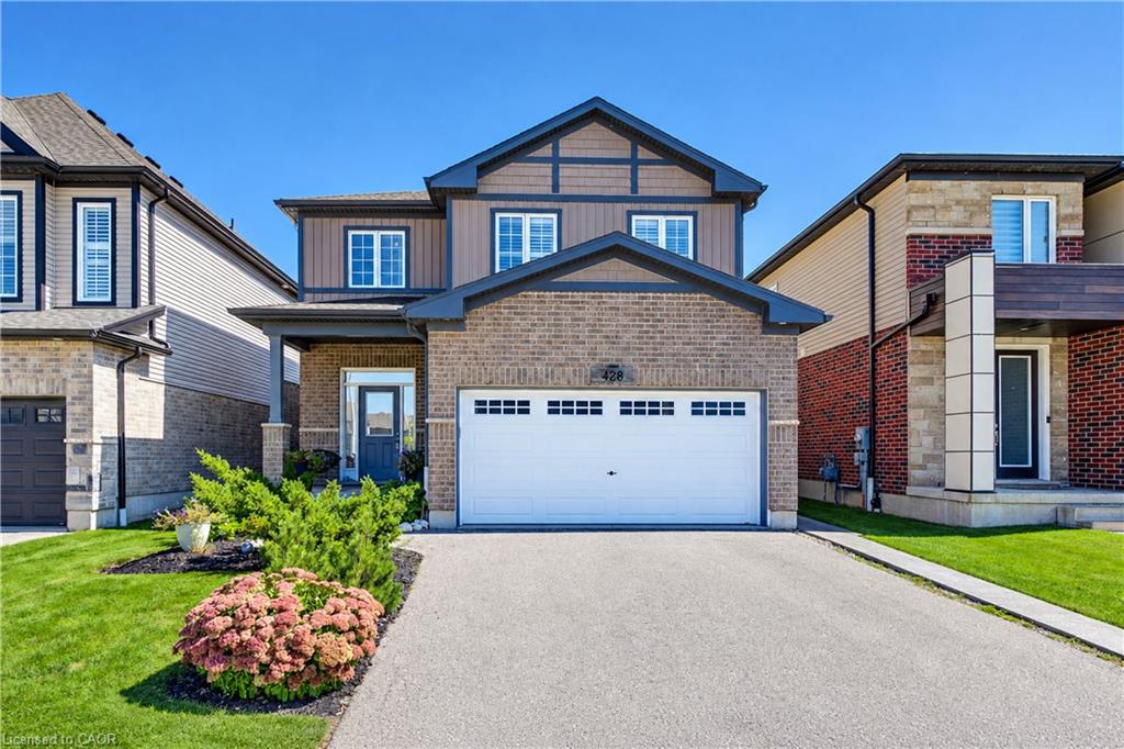 Brick and siding exterior with a two-car garage, covered entry, and landscaped front yard