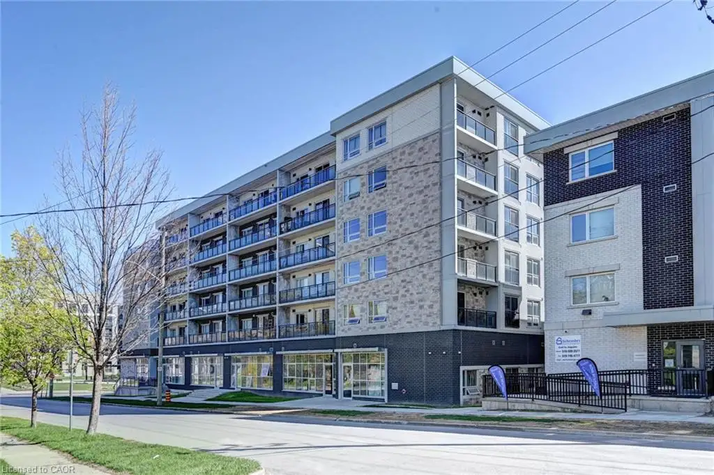 Contemporary multi-story building featuring a facade of light-toned brick, stone cladding, and dark brick accents