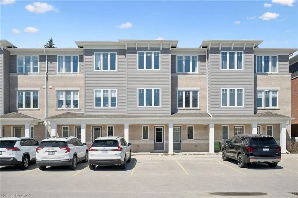 View of apartment building / complex featuring uncovered parking