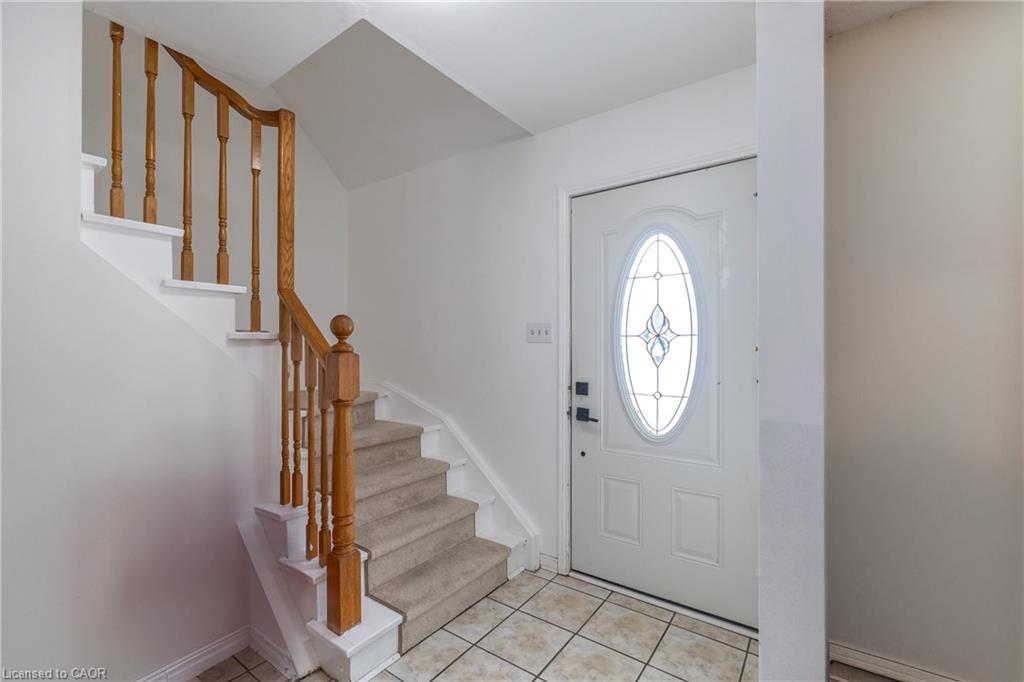 Entrance foyer featuring stairs and light tile patterned floors