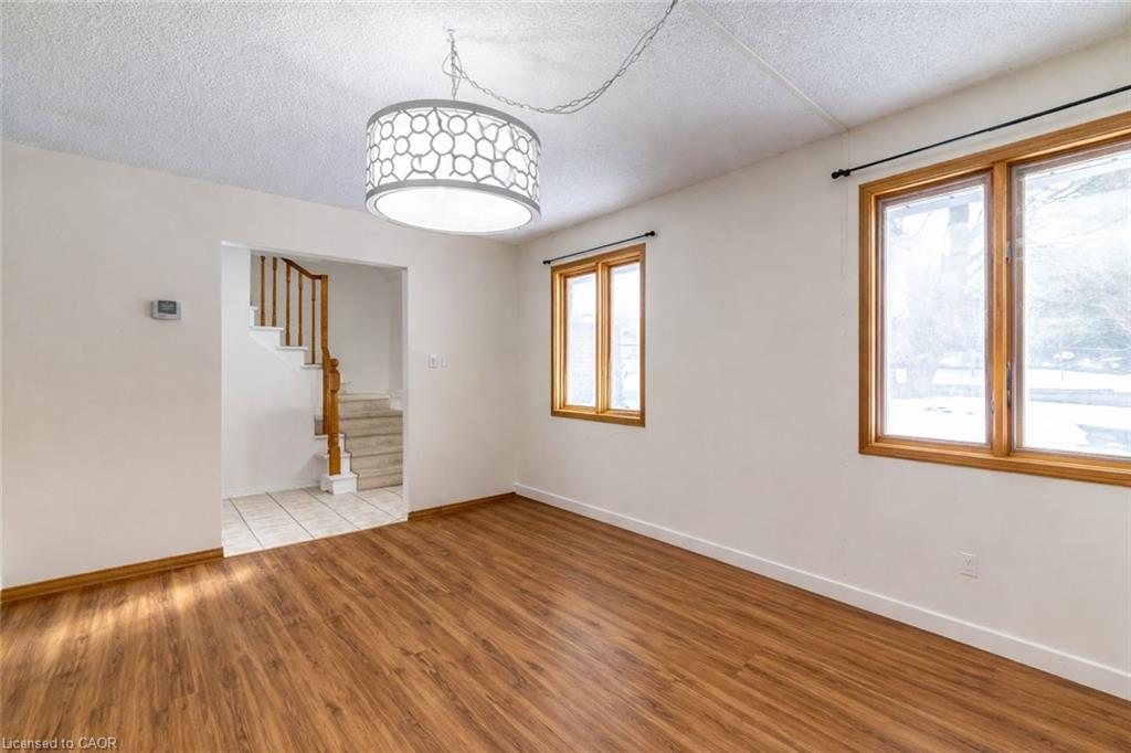 Spare room with light wood-style flooring and a textured ceiling