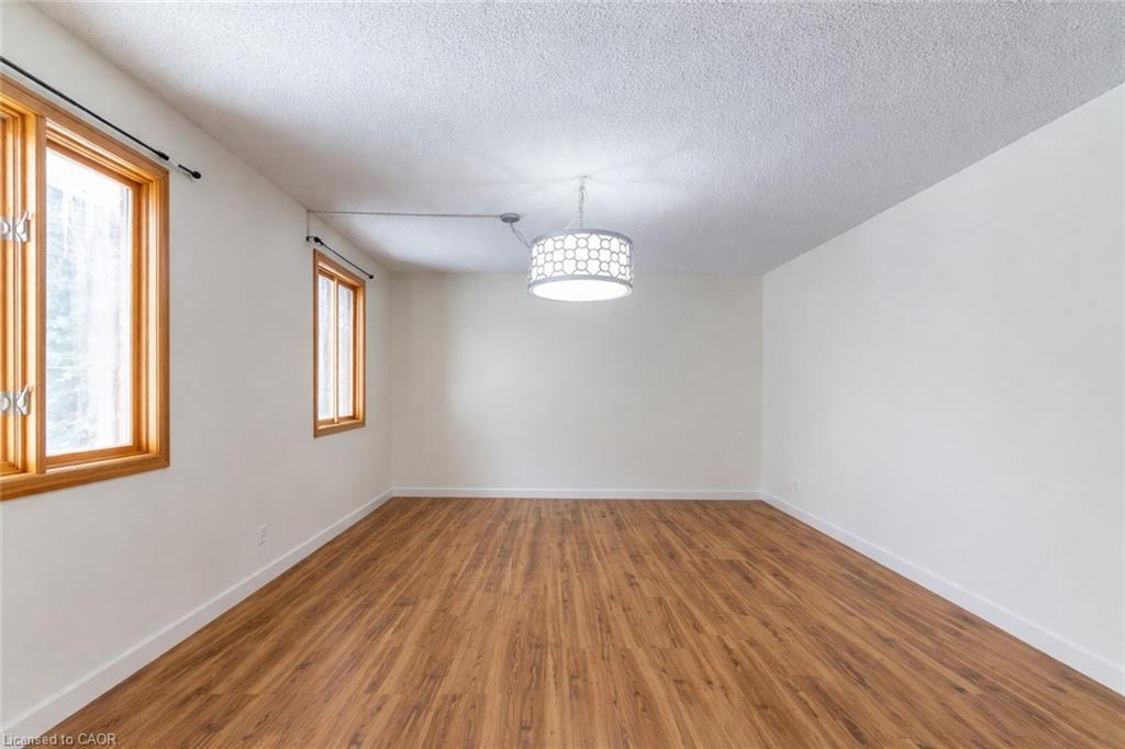 Spare room featuring a textured ceiling and wood finished floors