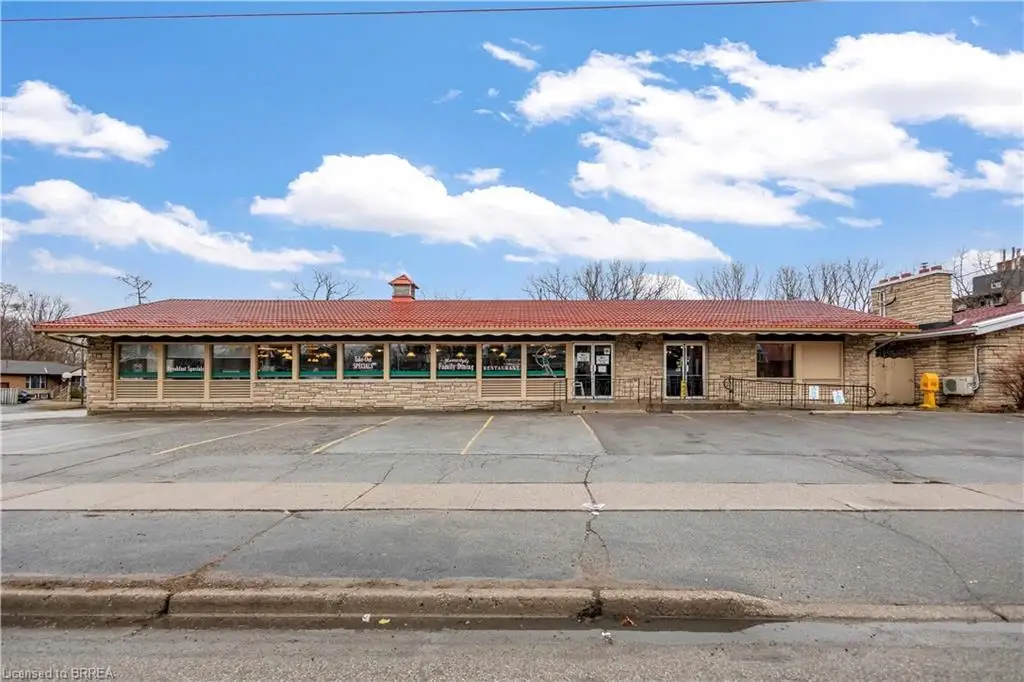 View of property with uncovered parking