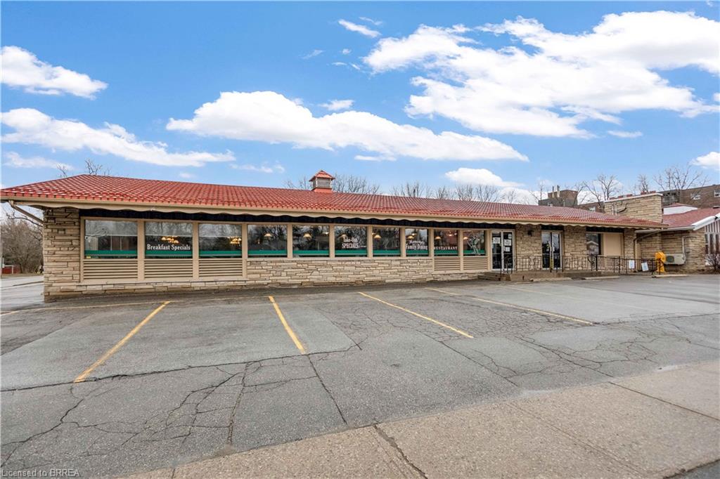 View of commercial property featuring uncovered parking