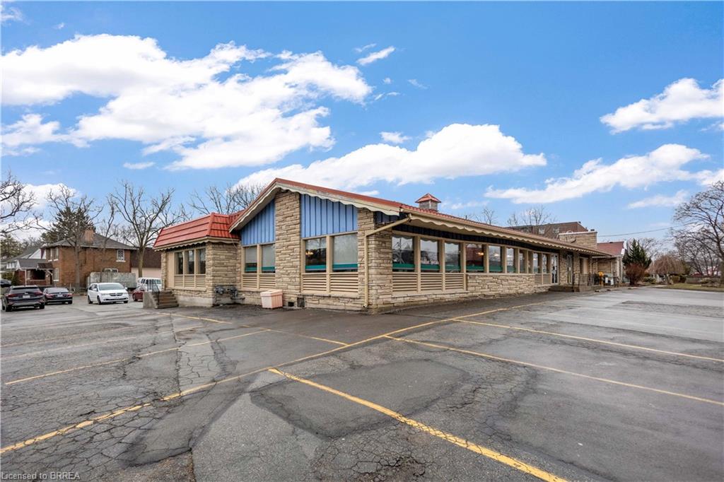 View of property featuring uncovered parking