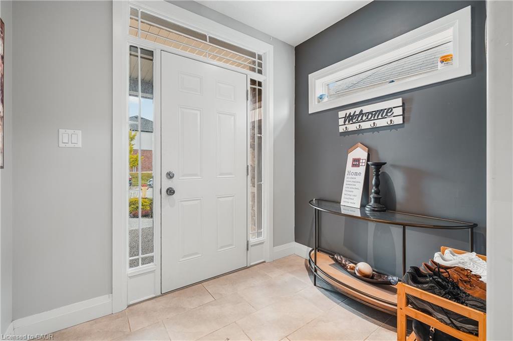 Tiled entryway featuring baseboards