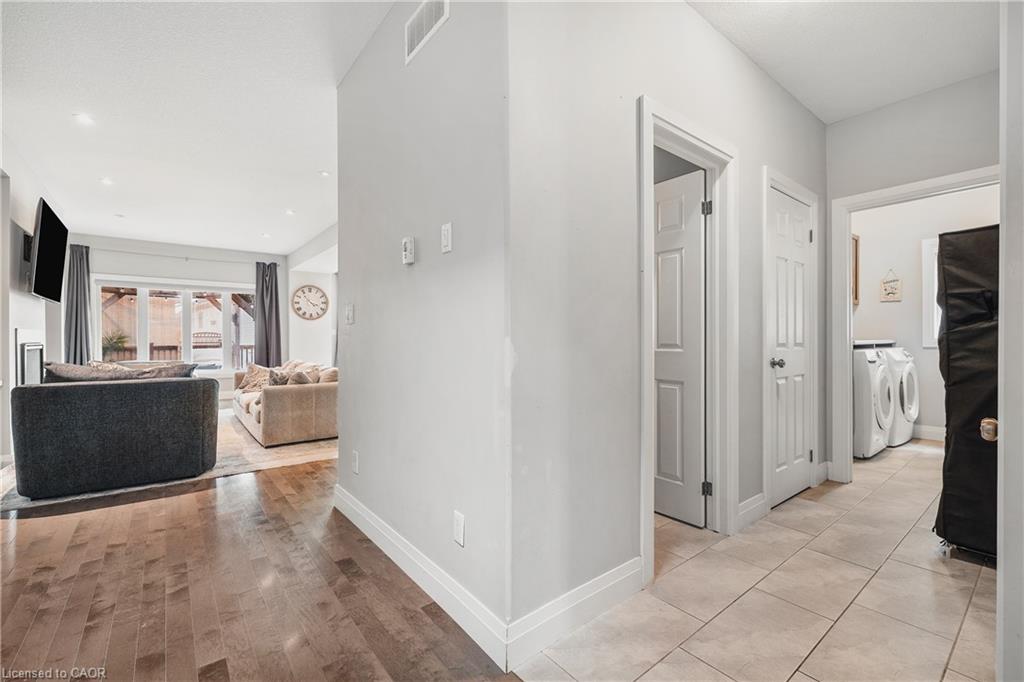 Corridor featuring washer and clothes dryer, recessed lighting, and light wood-style flooring