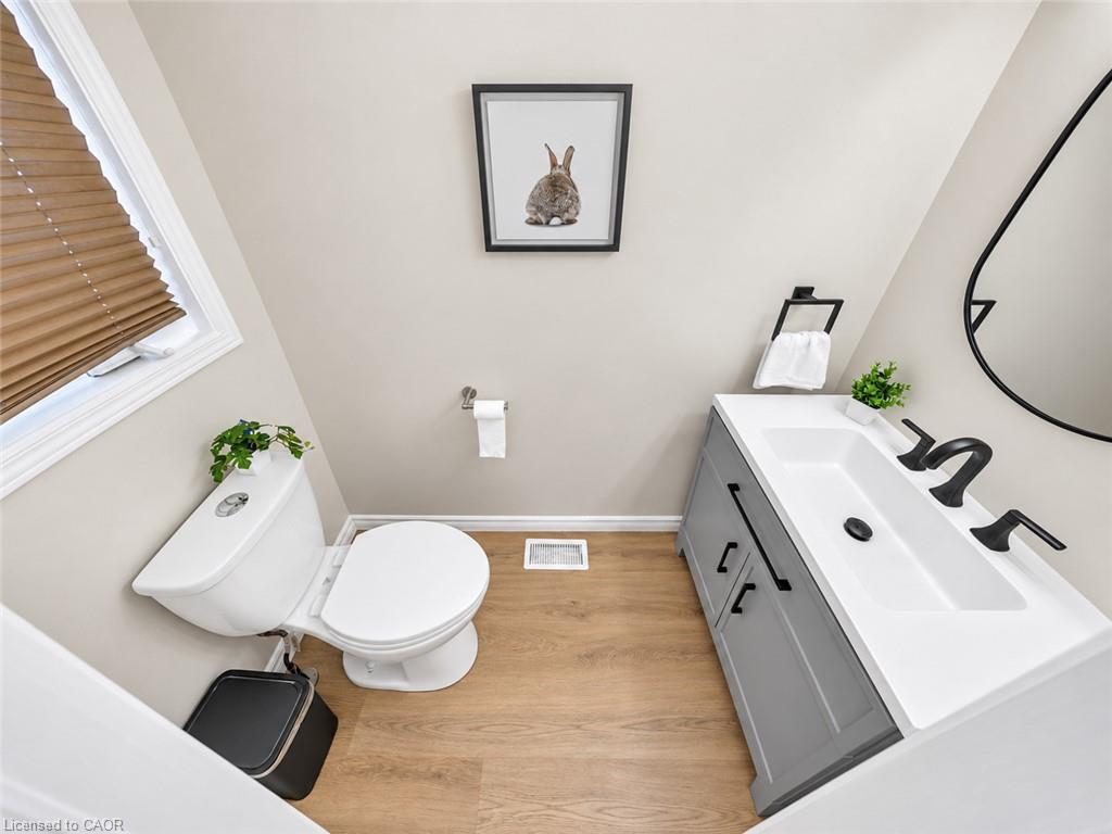 Gray vanity with black hardware, white rectangular basin, and matte black faucet