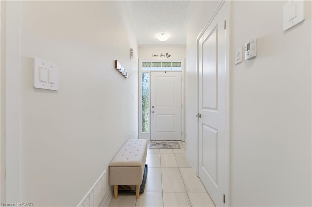 160 Middleton Street, Thamesford, Foyer Featuring a White Entry Door with Frosted Glass Detailing, Overhead Transom Window, and a Flush-Mount Ceiling Light