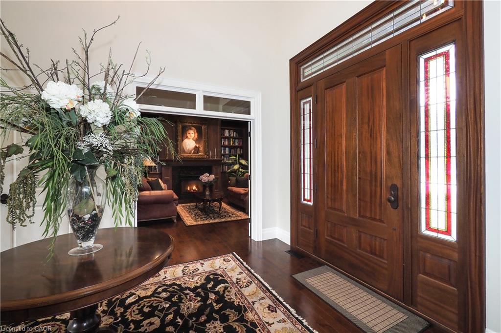 Rich wood entry door with stained glass sidelights and transom