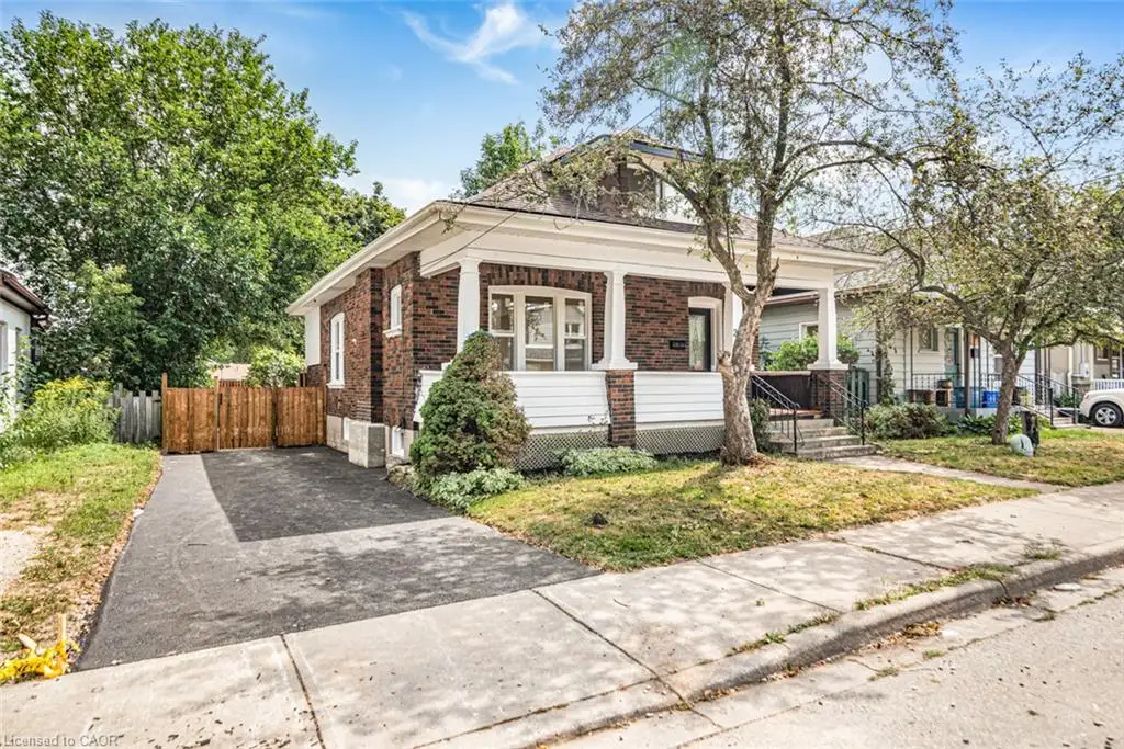 Brick exterior with white siding accents and a covered front porch featuring white columns