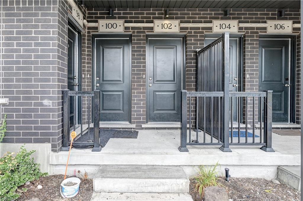 Brick exterior with multiple panel doors and individual unit numbering