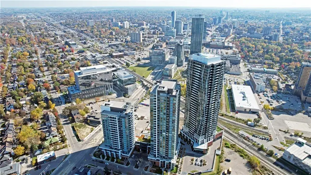 High-rise condominium complex featuring glass-paneled exteriors, private balconies, and a multi-level podium structure