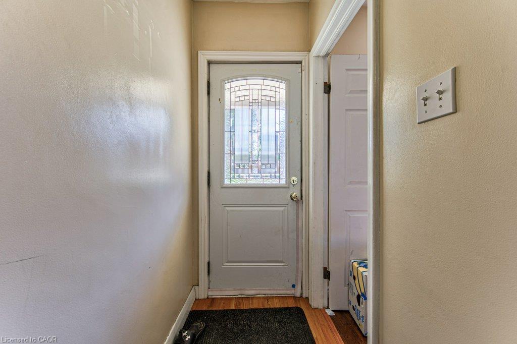 White entry door with an arched decorative glass insert