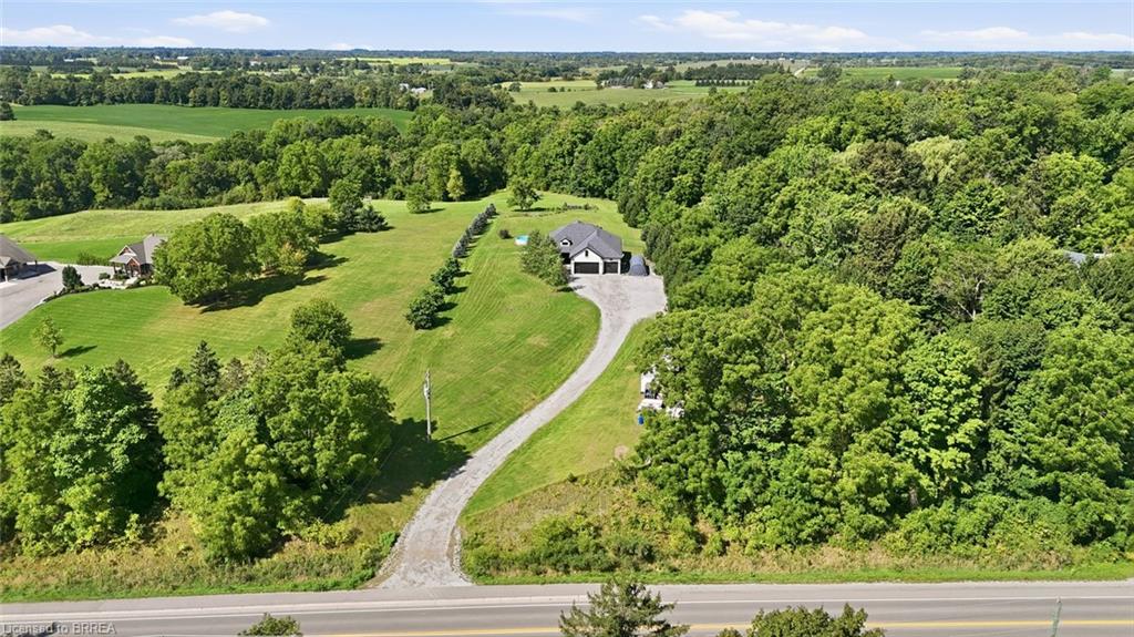 Expansive landscaped grounds with a long gravel driveway