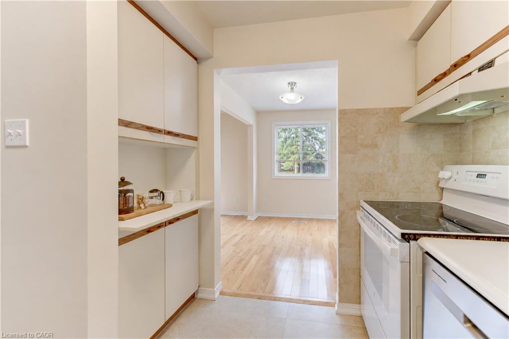 White cabinetry with wood-finish handles and integrated shelving