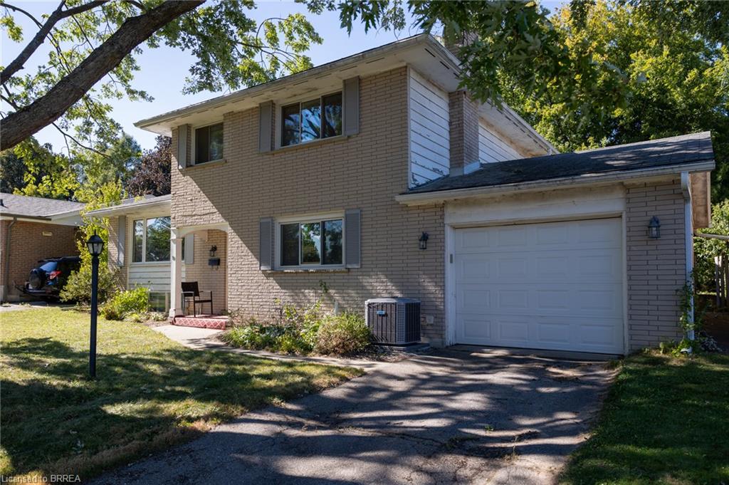 Brick exterior with white siding accents and a single-car garage