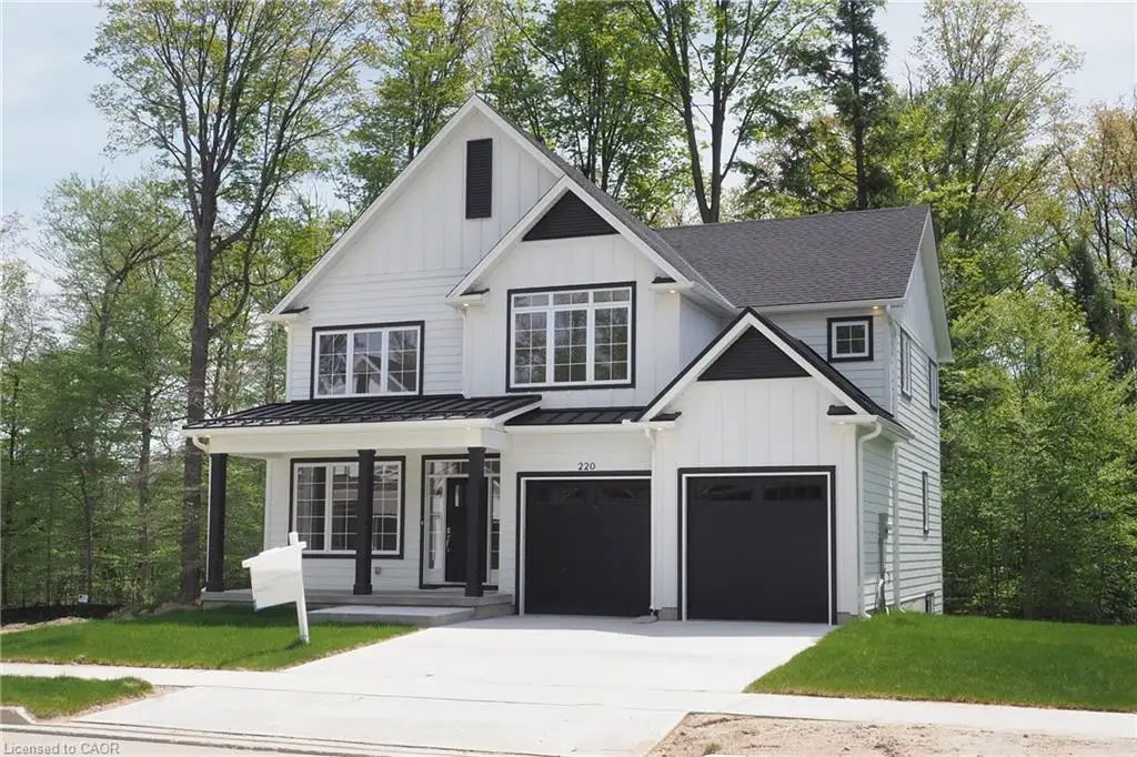 Contemporary farmhouse exterior with white board-and-batten siding, black trim windows, a covered front porch with dark columns, a two-car garage, and a concrete driveway
