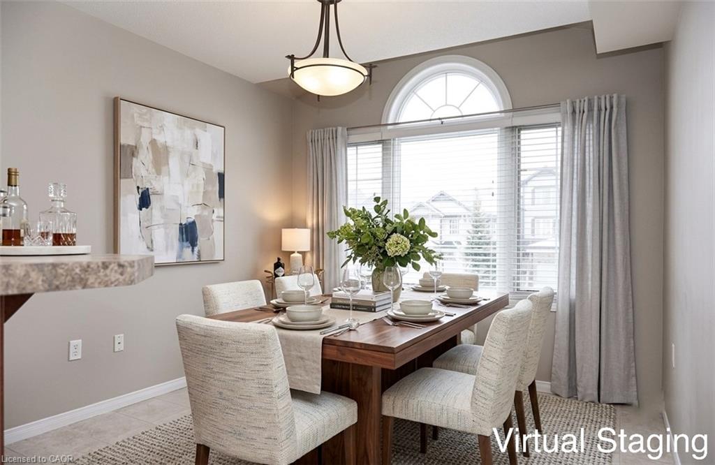 Dining area featuring an arched transom window, a rectangular window with blinds and drapes, and a ceiling-mounted light fixture
