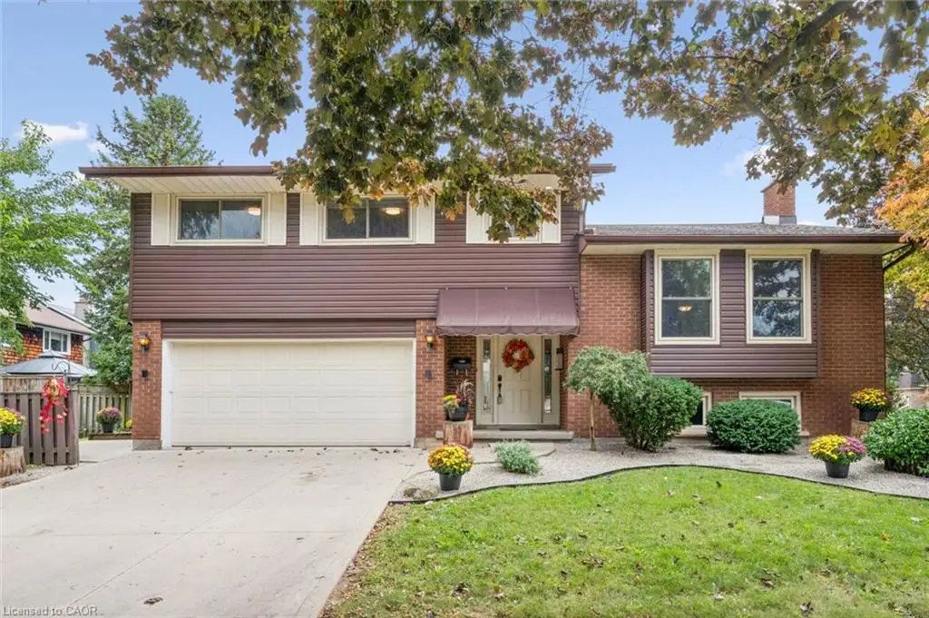 Brick and siding exterior with a pitched roof, attached two-car garage, and concrete driveway
