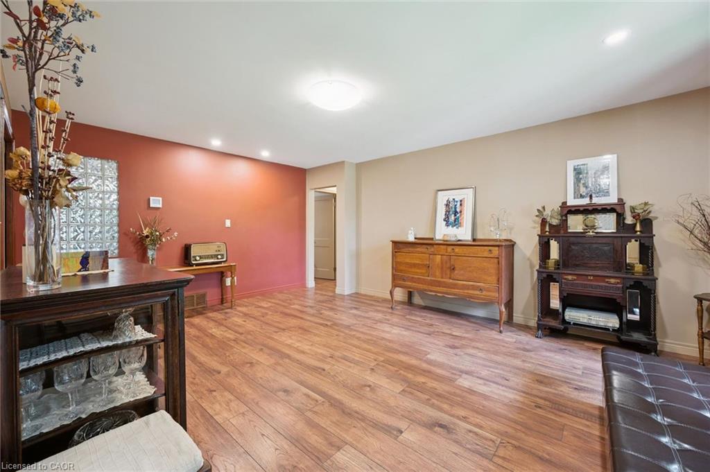 Spacious front room with country style laminate flooring and several LED overhead lights