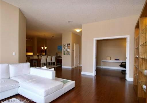 Hardwood-finish flooring throughout, recessed lighting, and a built-in shelving unit with glass shelves