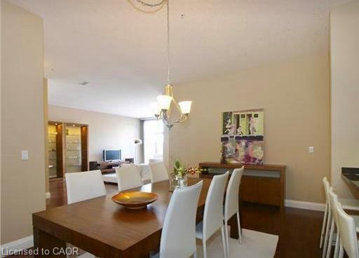 Open-concept living and dining area with dark wood-finish flooring